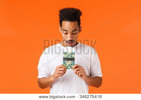 Dreamy And Wondered, African-american Guy Imaging Best Vacation Ever, Holding Passport With Tickets,