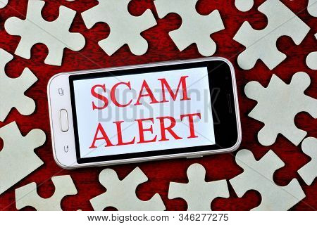 Fraud Alert-a Message On The Smartphone Screen. Fraud Is The Theft Or Acquisition Of The Right To So