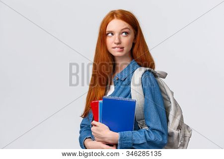Creative And Thoughtful Cute Daring Foxy Girl With Red Hair, Hold Backpack And Notebooks, Biting Lip