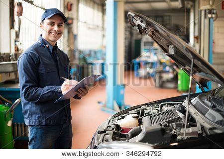 Portrait of a mechanic at work in his garage