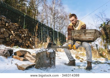 Man chopping wood with an axe, pieces and debris flying around, dynamic action scene