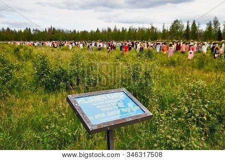 Suomussalmi, Finland - July 24, 2019: A Sign Near The Field With The Group Of Objects In People Clot