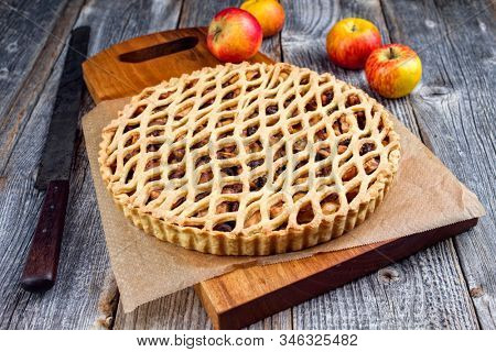 Traditional apple jalousie cake offered as closeup on a modern design wooden board 