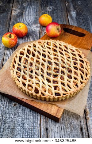 Traditional apple jalousie cake offered as closeup on a modern design wooden board 