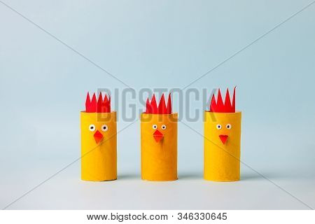 Set Of Paper Yellow Chicken For Happy Easter Seasonal Party. Easy Craft For Kids On Blue Background,