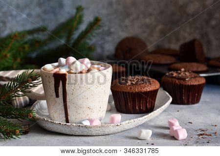 Christmas Drink - Hot Chocolate With Marshmallows And A Cupcake On A Concrete Background.