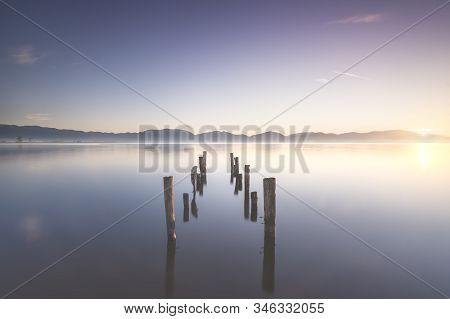 Wooden Pier Or Jetty Remains And Lake At Sunrise. Long Exposure. Torre Del Lago Puccini, Versilia, M
