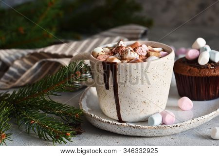 Hot Chocolate With Marshmallows And Muffin On A Concrete Background.