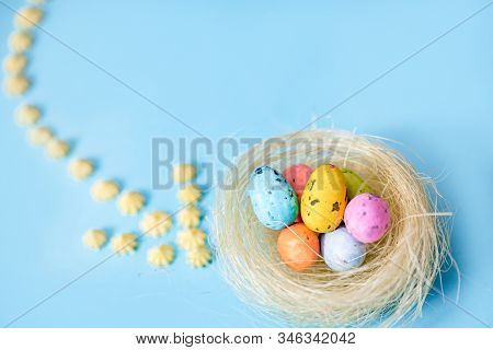 Plane Flies On Blue Background.yellow Sweets. Direction Sign For Easter Eggs. Spring And Easter Are 
