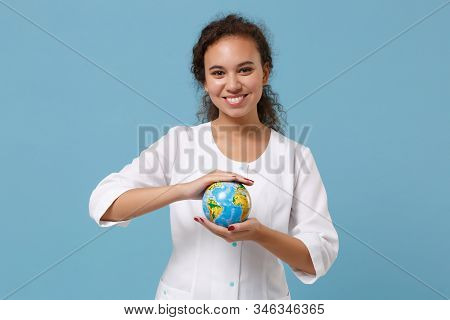 Smiling African American Doctor Woman Isolated On Blue Wall Background. Female Doctor In White Medic