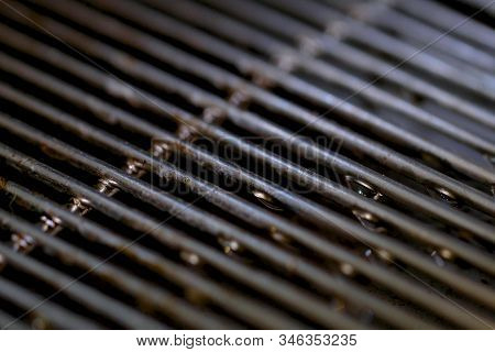 Metal Grill With Water Drops. There Is Hot Air Steam.