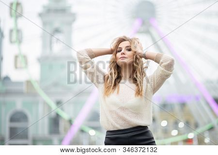 Gorgeus Blonde Woman In Leather Skirt Posing On The Ferris Wheel Background