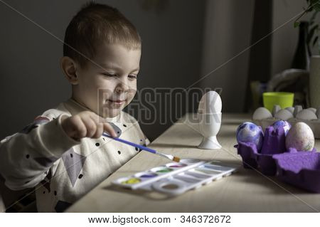 Toddler Boy Painting Easter Eggs Preparing For Holidays. Easter Tradition