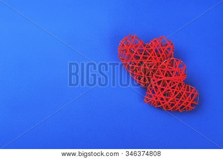 Two Beautiful Red Hearts On Cornflowerblue Background. St Valentines Concept With Copy Space.