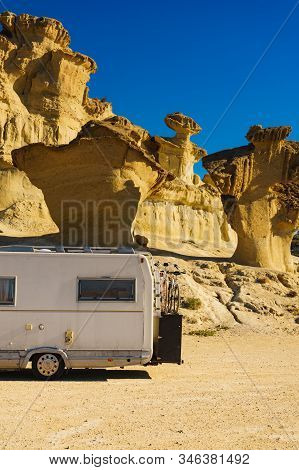 Camper Car On Parking Area At Eroded Yellow Sandstone Formations, Enchanted City Of Bolnuevo, Murcia