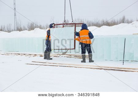 Slingers In Special Winter Overalls For Shipment Of Ice Blocks