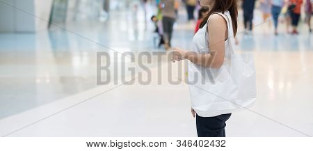 Woman Hand Holding Eco Shopping Bag In Store Background With Copy Space For Text. Environmental Prot