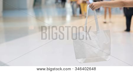 Woman Hand Holding Eco Shopping Bag In Store Background With Copy Space For Text. Environmental Prot