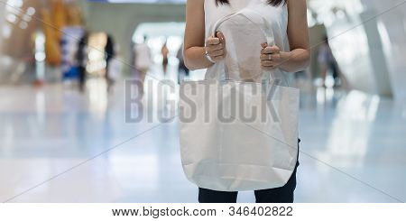 Woman Hand Holding Eco Shopping Bag In Store Background With Copy Space For Text. Environmental Prot