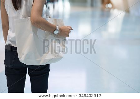 Woman Hand Holding Eco Shopping Bag In Store Background With Copy Space For Text. Environmental Prot
