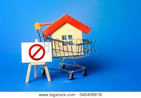 House In A Shopping Cart And An Easel With A Red Prohibition Sign No. Inaccessibility, Lack Of Housi