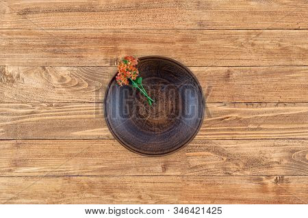Empty Flat Plate Of Red Clay Over Rustic Wooden Background .top View. Flat Lay.