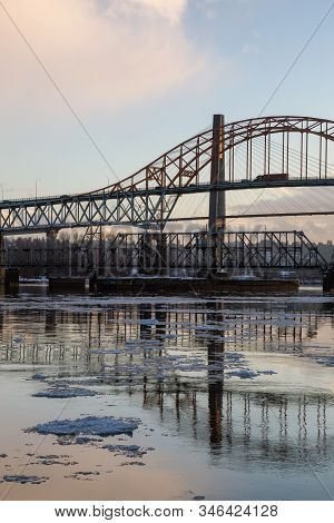 Beautiful View Of Fraser River And Pattullo Bridge In The City During A Cold And Icy Winter Sunset. 
