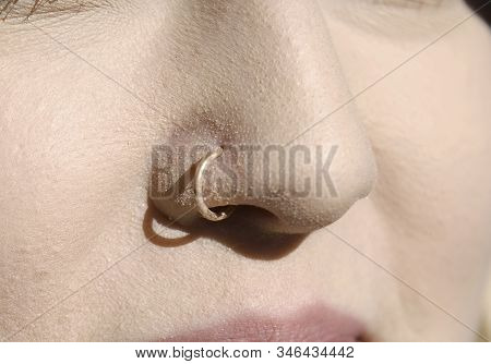 Close Up Of  A Gold Nose Ring.