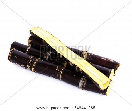 Studio Shot Heap Of Organic Sugarcane Stalks With Half Cuts Isolated On White