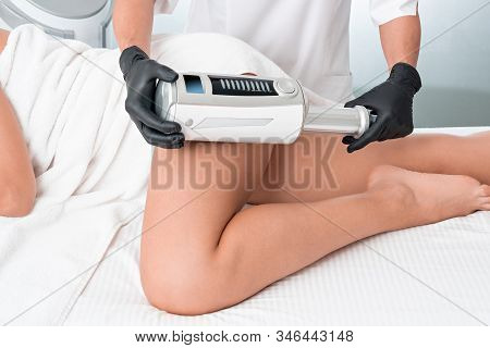 Cosmetologist In Rubber Gloves Doing Endospheres Therapy On Female Hips
