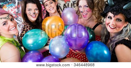 Group of cheerful women at Rose Monday making party with balloons