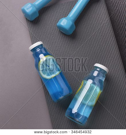 Lets Be Healthy. Blue Detox Drink With Lemon Slices For Weight Loss, Sporty Lifestyle, Exercises Wit