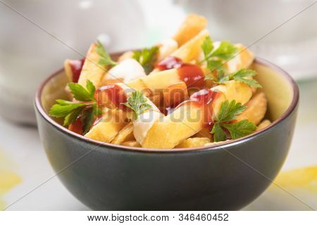 Canadian poutine, fried potato chips with cheese and gravy or sauce