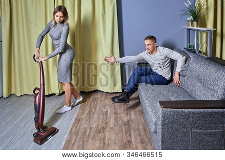 Sexism In The Workplace, A Businessman Pestering A Young Cleaning Lady. Sexual Harassment In The Off