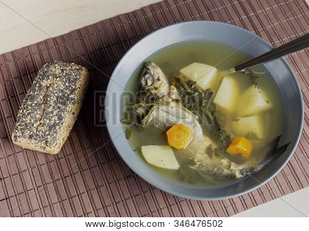 The Fresh, Delicious Fish Soup Of Sea Bass With Celery On A Green Plate On The Table Close-up