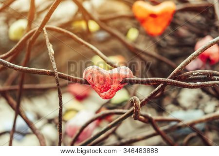 A Chunk Of A Red Heart Shaped Candle Adheres To An Old Rusted Steel Rod.  A Valentine's Day Backgrou