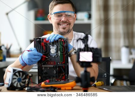 Male Adult Vloger Make Online Broadcast Portrait. Tells Subscribers How To Repair Motherboards And B
