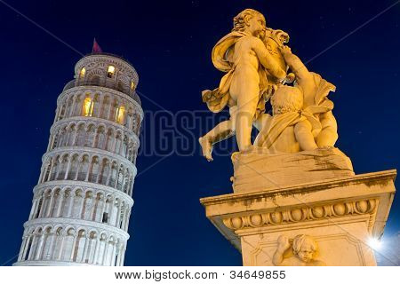Leaning Tower of Pisa with statue after sunset, Tuscany, Italy