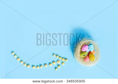 Plane Flies On Blue Background.yellow Sweets. Direction Sign For Easter Eggs. Spring And Easter Are 