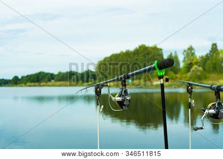 Carp Fishing On Beautiful Blue Lake With Carp Rods And Rod Pods In The Summer Morning. Fishing From 