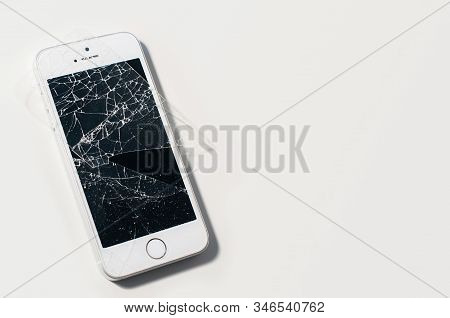 Modern Smartphone With Seriously Broken Display Screen Isolated On White Background.