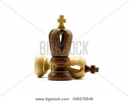 Defeated White King Chess Piece Lying Behind A Standing Black King, Isolated On White Background