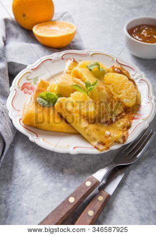 Crepe Suzette. Traditional French Crepe Suzette With Orange Sauce . Top View, Flat Lay