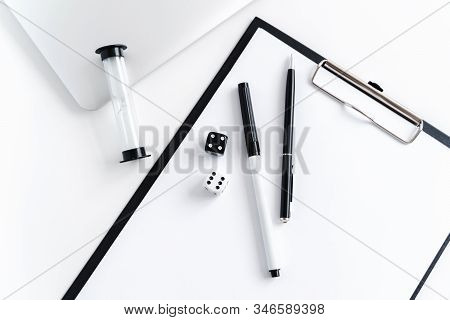 Coaching Business Tools Like Hourglass, Notebok, Dice, Pens And Tablet On A White Wooden Background.