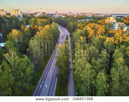 Aerial View Of Asphalt Road Through Forest Near Espoo, Residential Suburb Of Helsinki, Finland