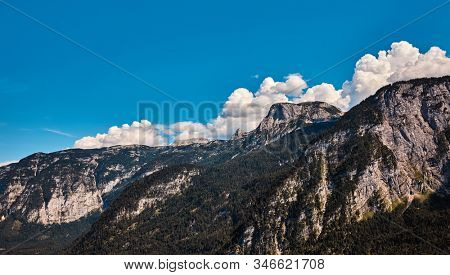 Snowbound summits of Alps mountains on Pasterze Glacier. Grossglockner, Austria. Blue sky with clouds.