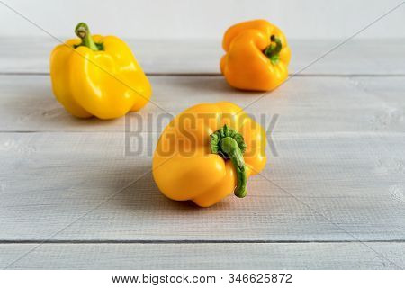 Trendy Ugly Food. Shaped Yellow Peppers On The Wooden White Background.misshapen Produce, Food Waste