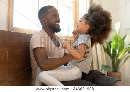 African Father Tickles Little Daughter Family Having Fun Indoors