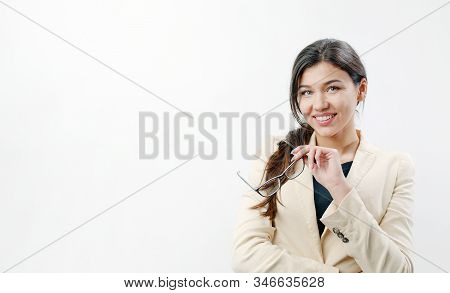 Portrait Of Attractive Dark Haired Smiling Woman Holding Glasses In Her Hand Isolated On White Backg