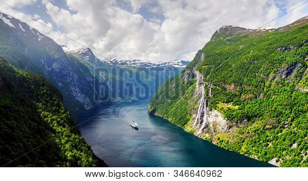 Panorama of breathtaking view of Sunnylvsfjorden fjord and famous Seven Sisters waterfalls, near Geiranger village in western Norway. Landscape photography